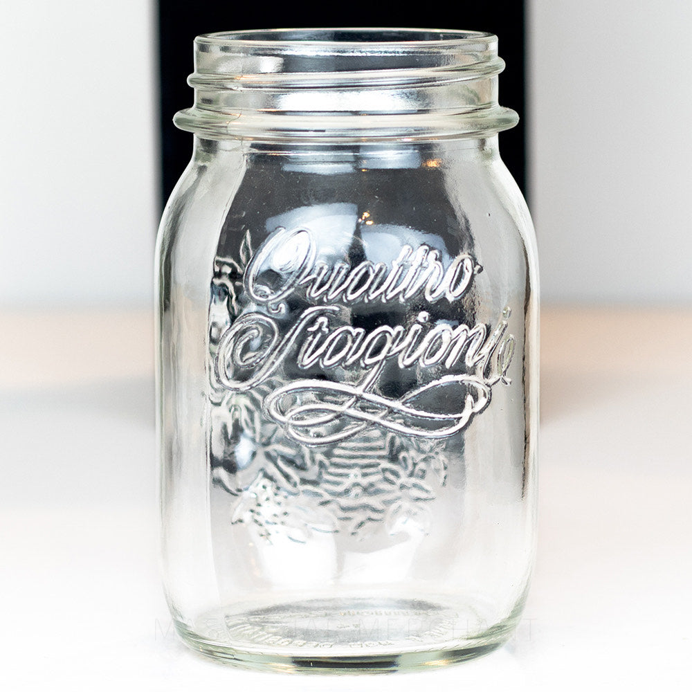 close up of a Regular mouth pint mason jar with Quattro Stagioni logo, on a white background