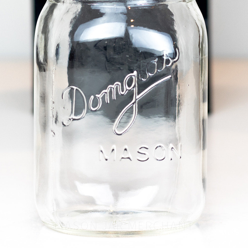 close up of a Regular mouth pint mason jar with Domglas logo on a white background