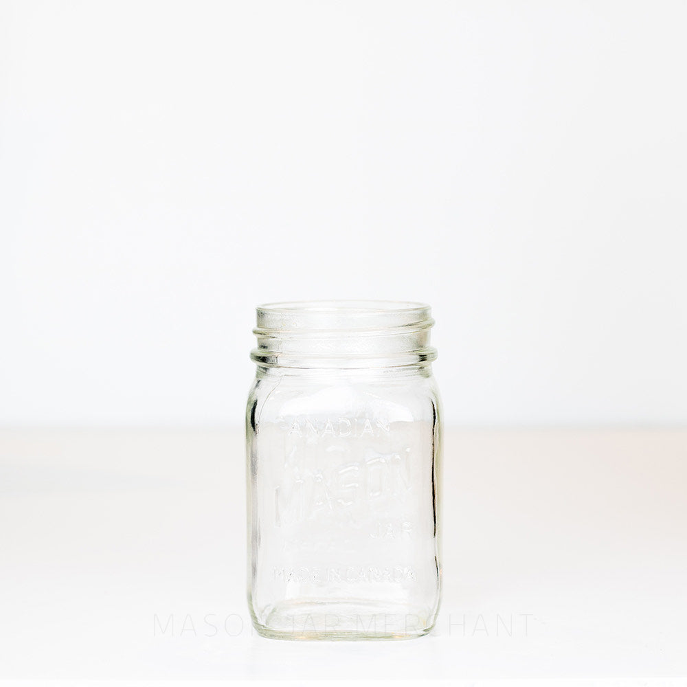 Regular mouth pint mason jar with Canadian Mason Jar, made in Canada logo, on a white background