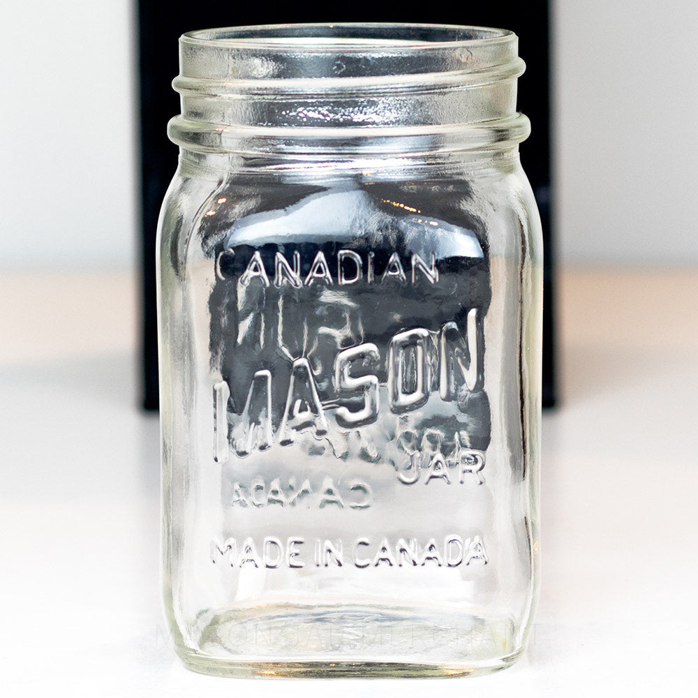 Regular mouth pint mason jar with Canadian Mason Jar, made in Canada logo, on a white background 