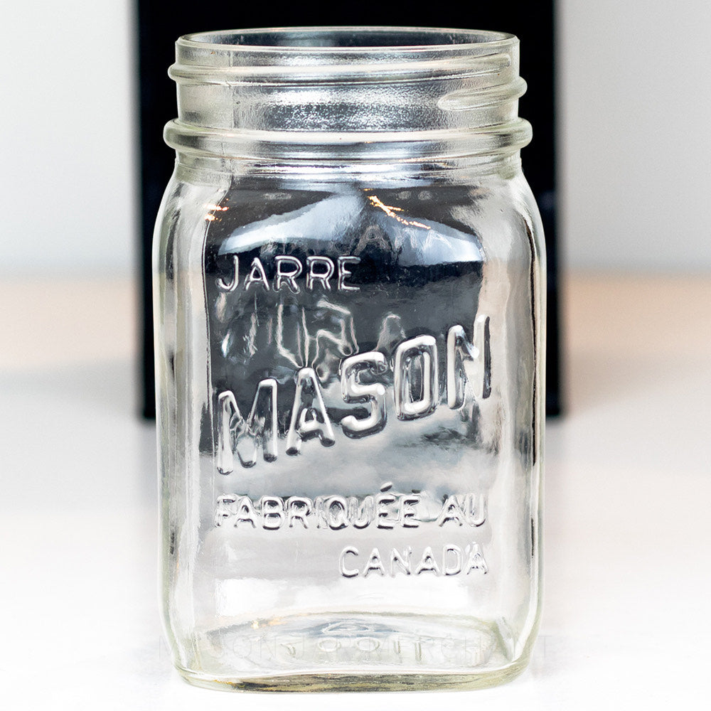 close up of a Regular mouth pint mason jar with Canadian Mason Jar, made in Canada logo, on a white background