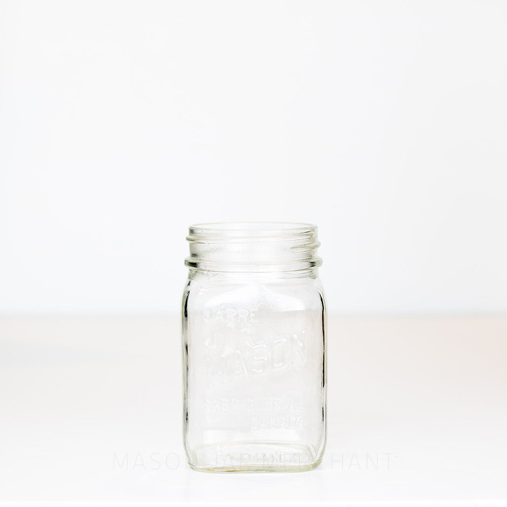 Regular mouth pint mason jar with Canadian Mason Jar, made in Canada logo, on a white background
