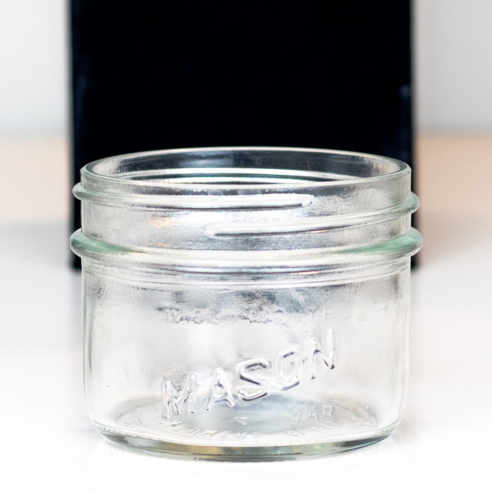 close up of a Wide Mouth Half Pint Mason Jar with Salmon on the side of the jar, shot on a white background.