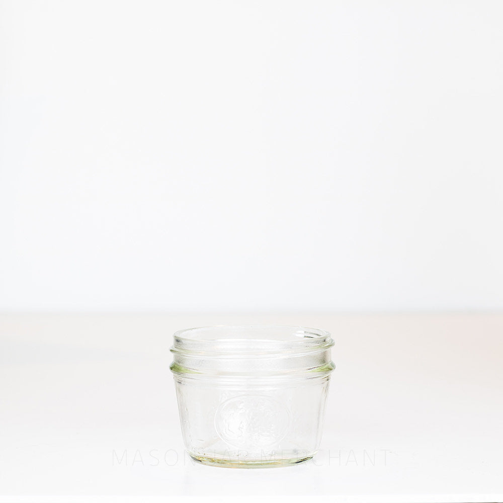 Half-pint wide mouth mason jar against a white background 