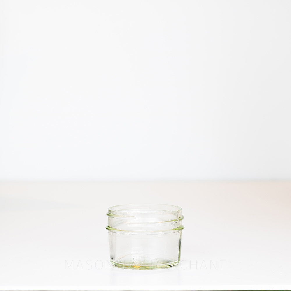 Adorable 2 oz. regular mouth mason jar with straight sides on a white background, perfect for spices!