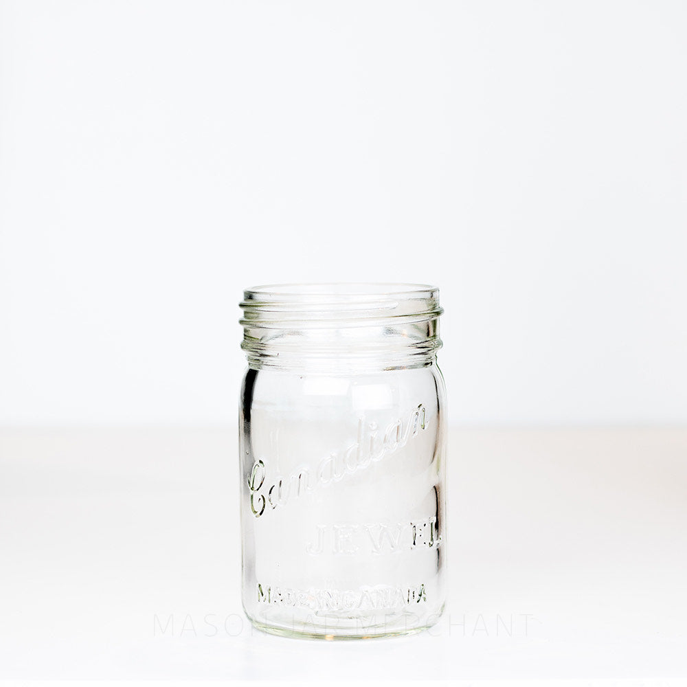Vintage gem mouth pint mason jar with Canadian Jewel logo on a white background 