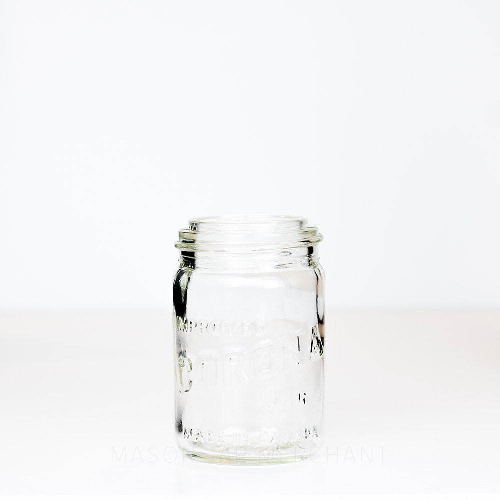 Vintage gem mouth pint mason jar with Improved Corona Jar logo, on a white background