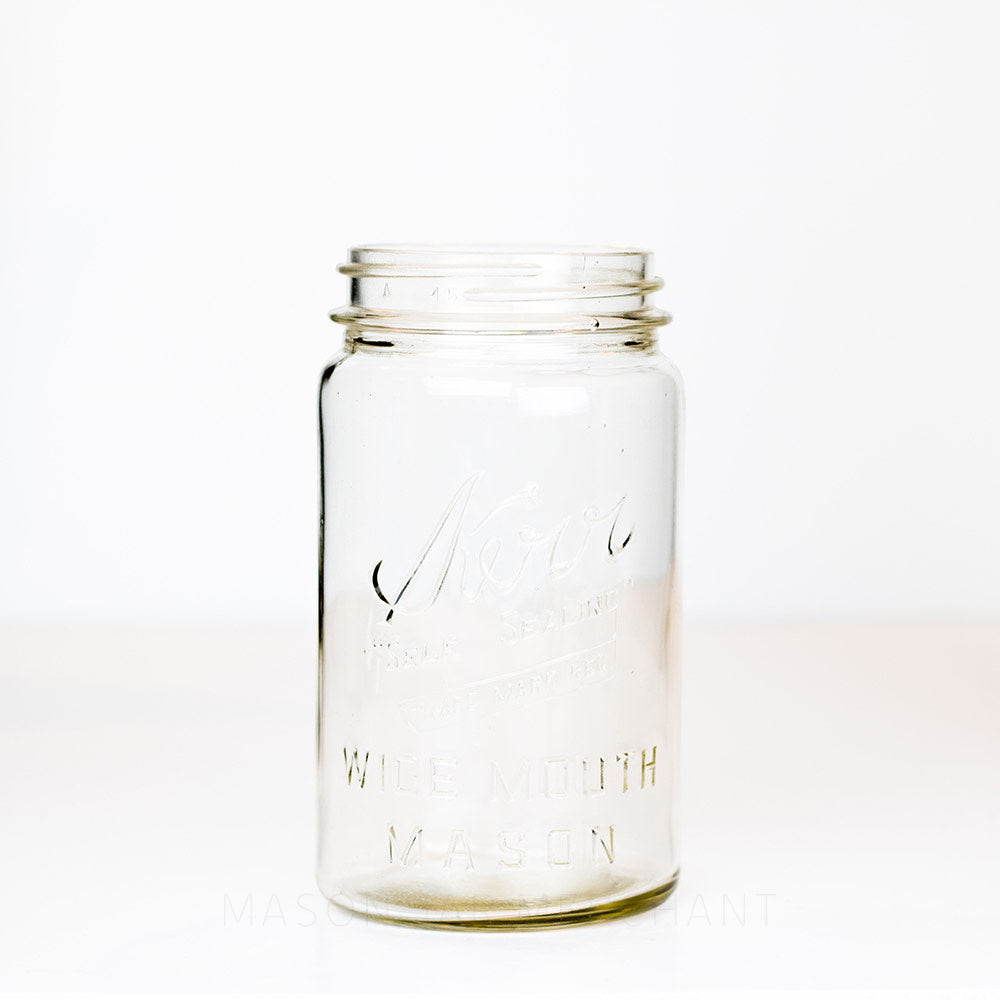 Vintage wide mouth quart mason jar with Kerr Wide mouth mason logo on a white background