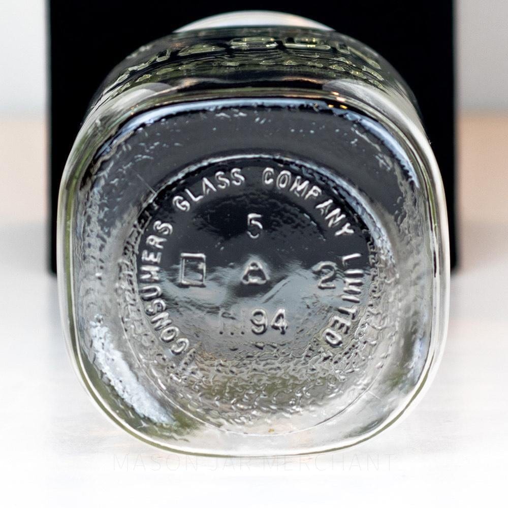 bottom of a Wide mouth quart mason jar with Mason logo against a white background