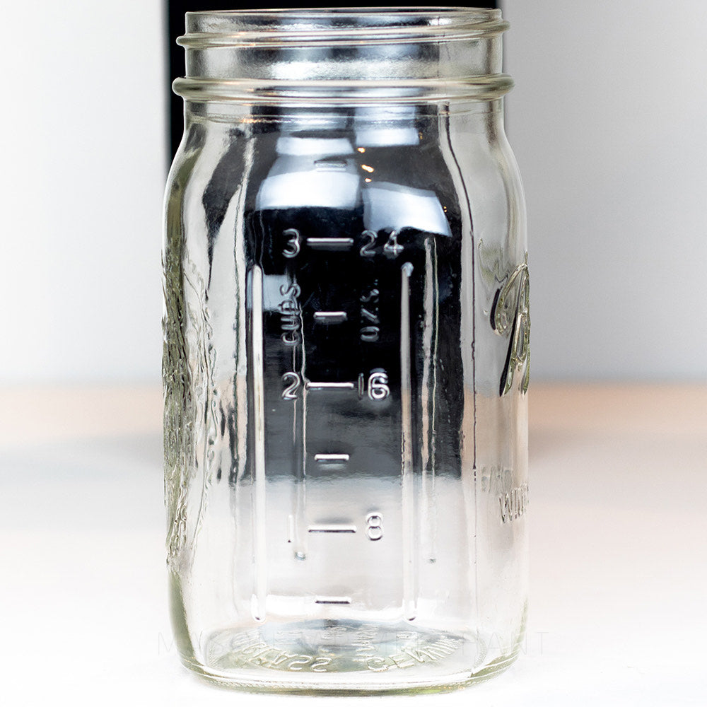 Back of a Wide mouth quart mason jar with Ball logo, against a white background