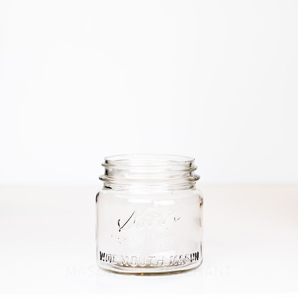 Short wide mouth pint mason jar with Kerr logo on a white background 
