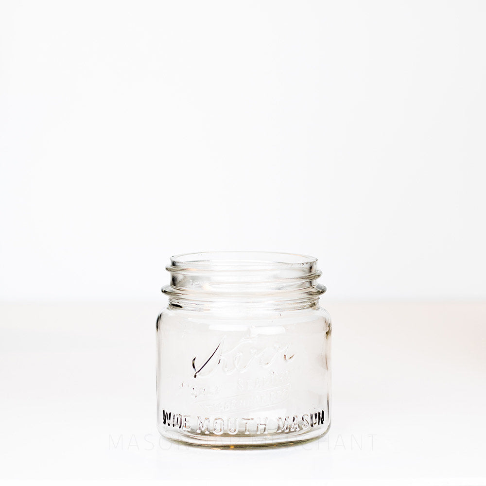 Short wide mouth pint mason jar with Kerr logo on a white background