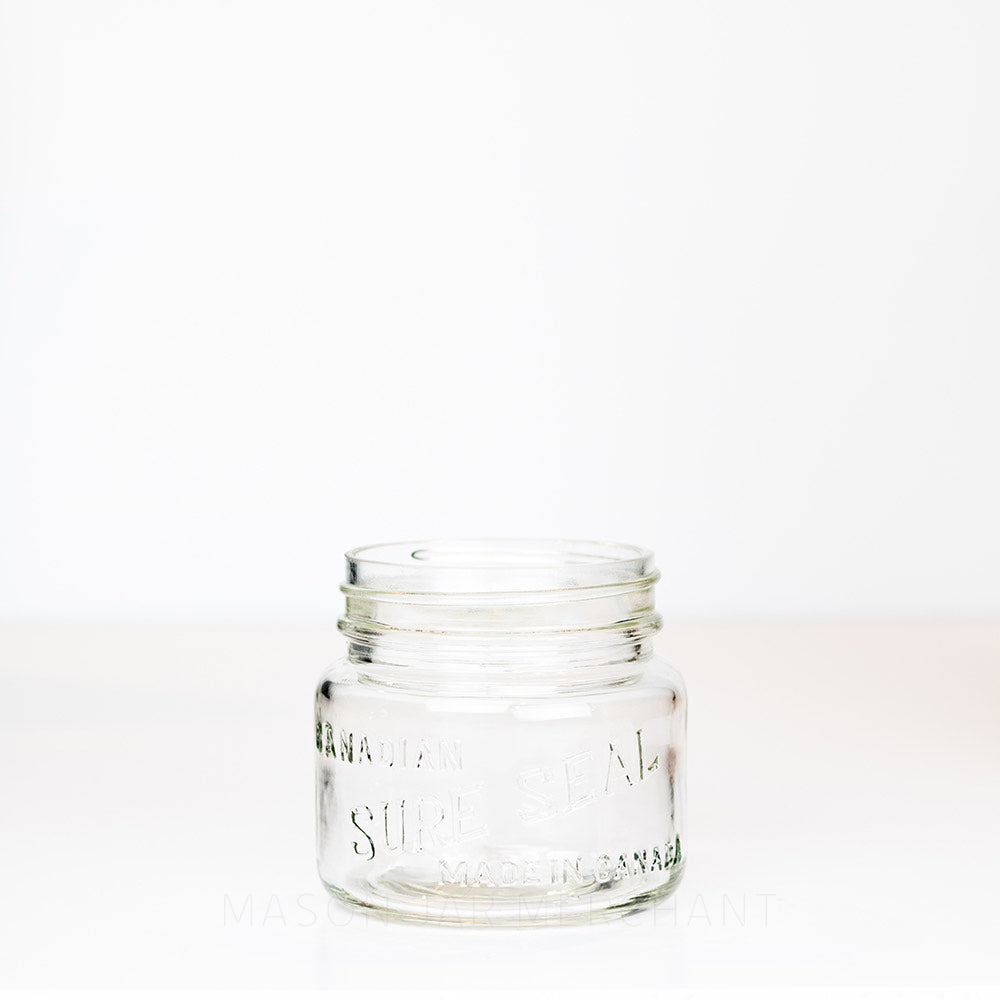 Vintage wide mouth pint mason jar with Canadian Sure Seal logo, against a white background 