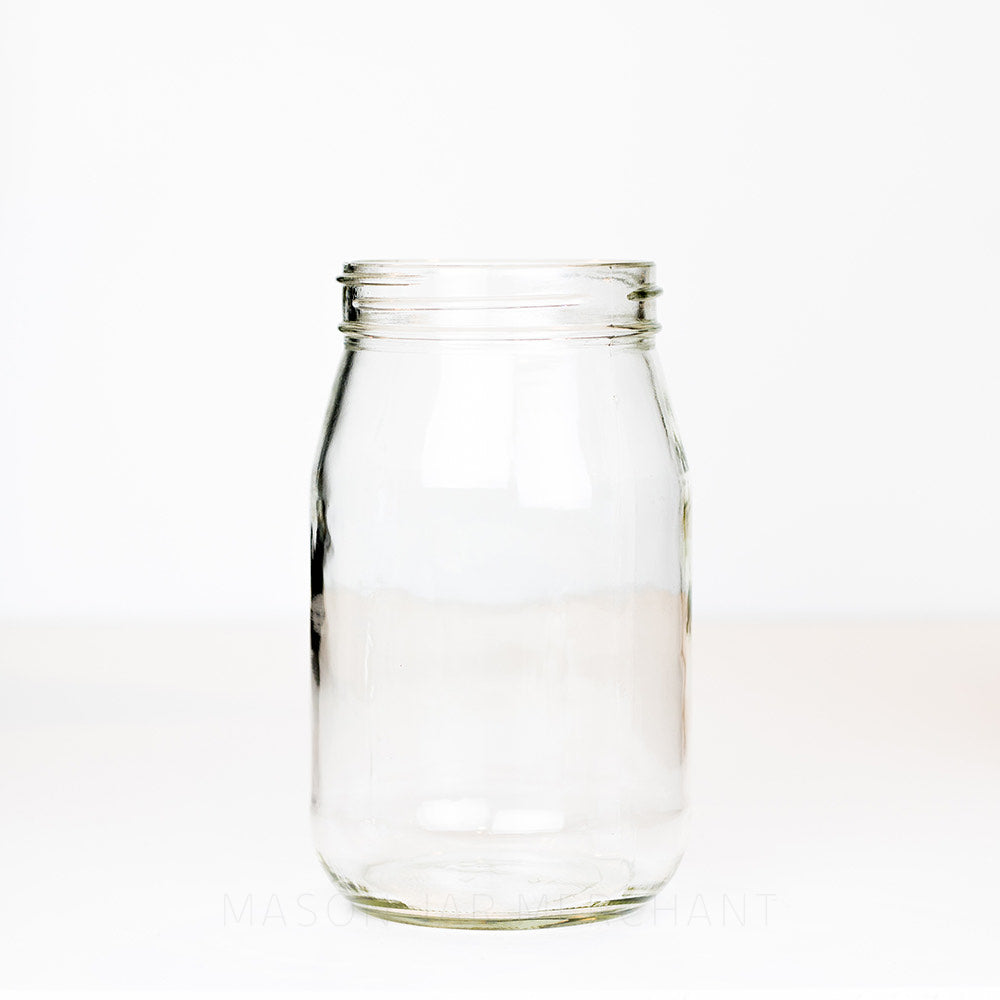 Wide mouth quart mason jar with plain sides and no logo on a white background