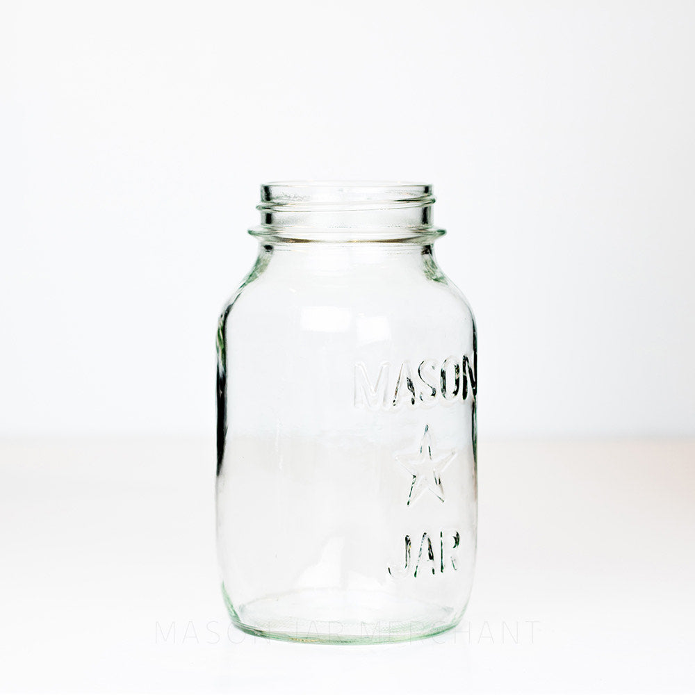 Side view of a Regular mouth quart mason jar with a star and Mason Jar logo, against a white background