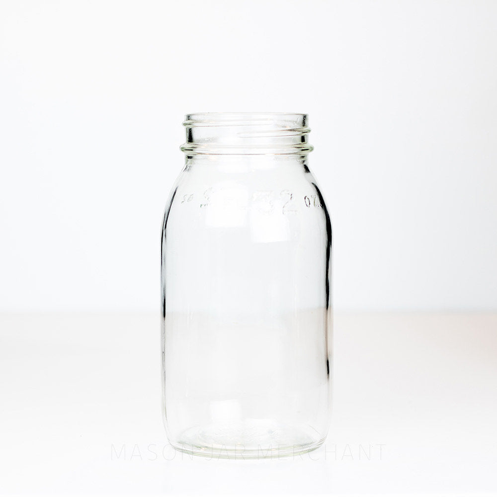 A 7 1/8 inches tall without lid regular mouth mason jar on a white background