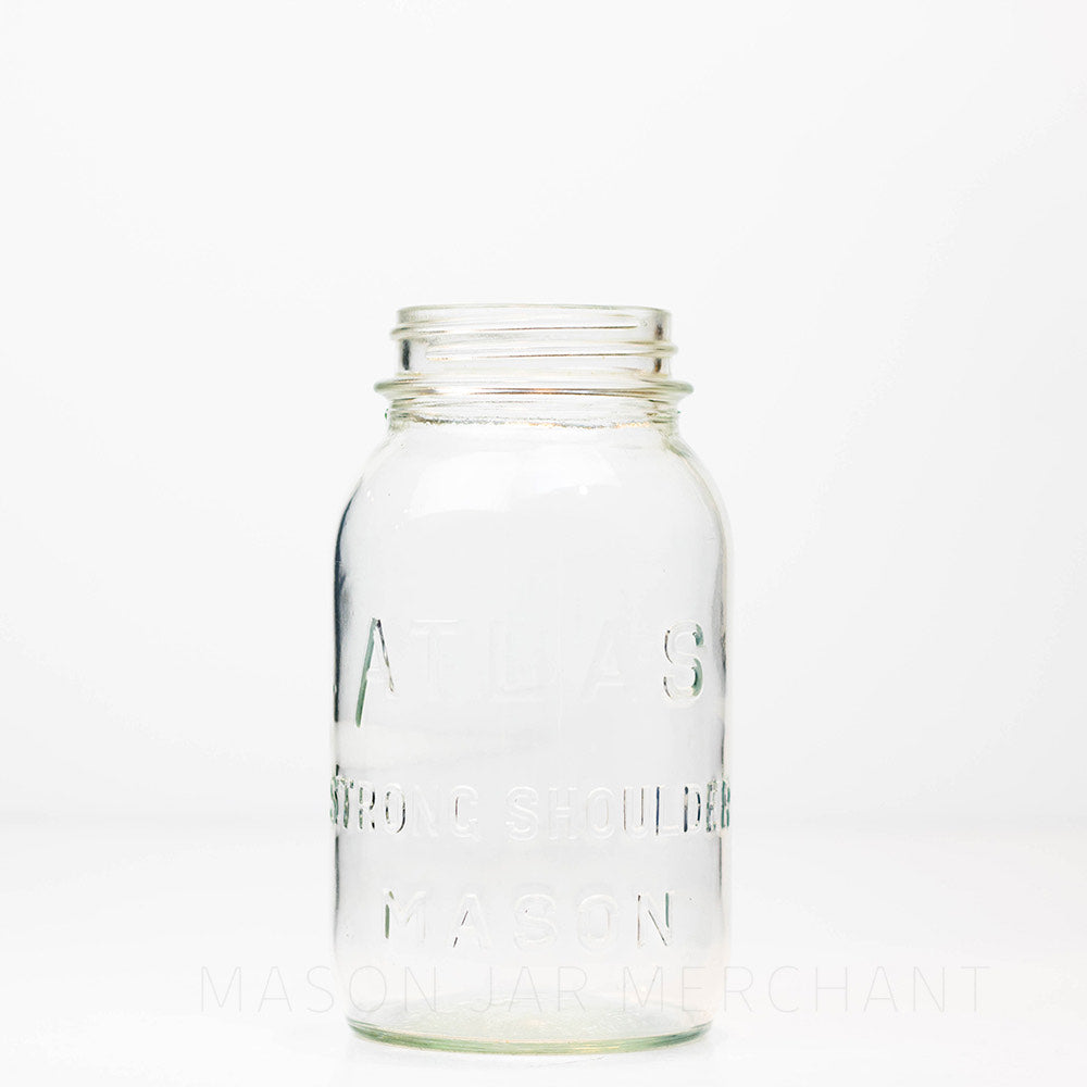 Vintage Atlas strong shoulder regular mouth quart mason jar against a white background