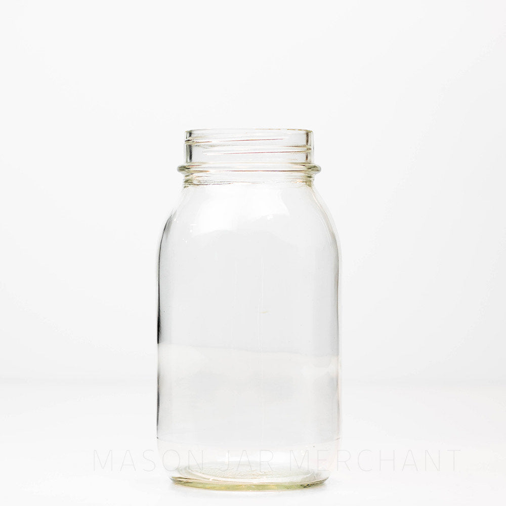 Plain regular mouth quart mason jar against a white background