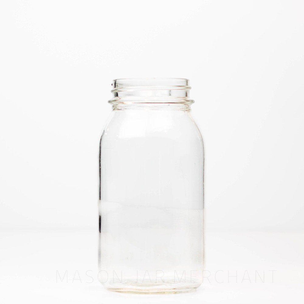 Plain regular mouth quart mason jar against a white background