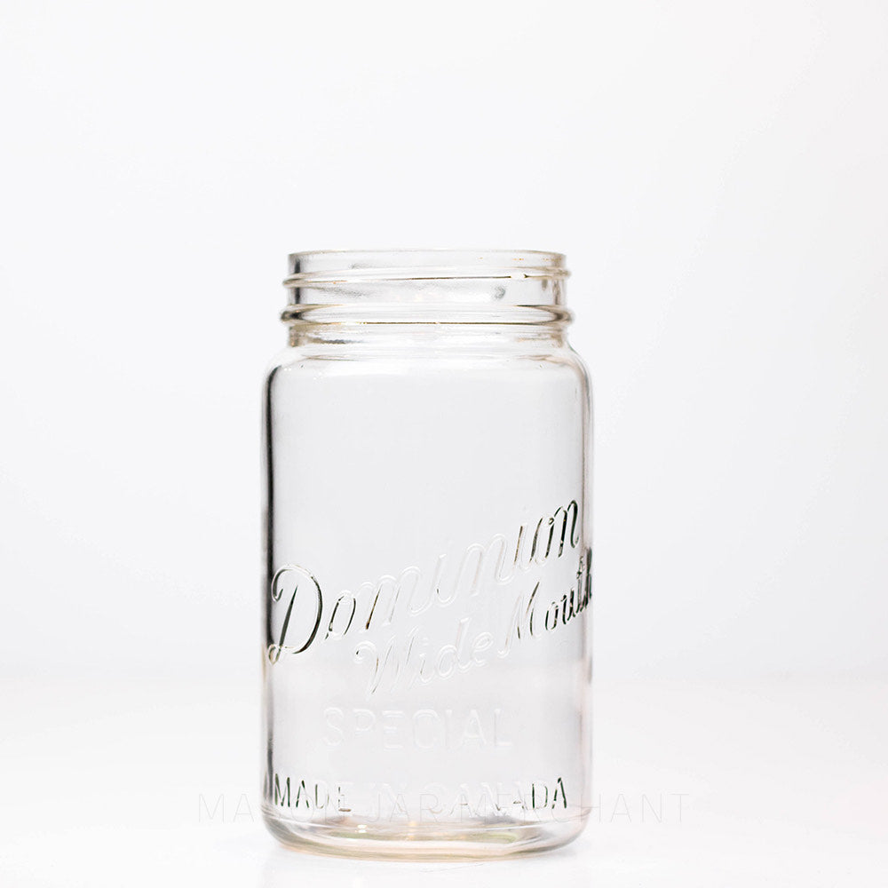 Vintage wide mouth Dominion mason jar quart against a white background