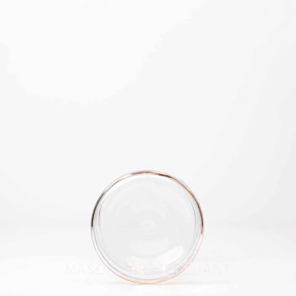 Bottom of a Vintage wide mouth Dominion mason jar quart against a white background