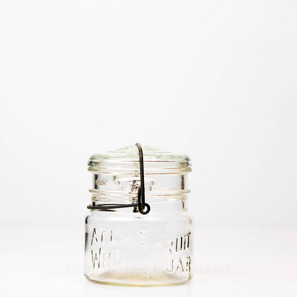 Vintage Atlas Wholefruit wide mouth wire bail mason jar against a white background