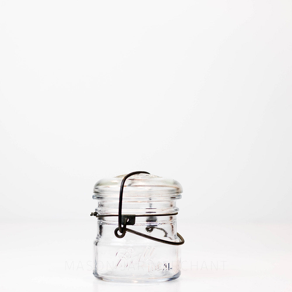Vintage 1920s almost half-pint wire bail Ball mason jar against a white background
