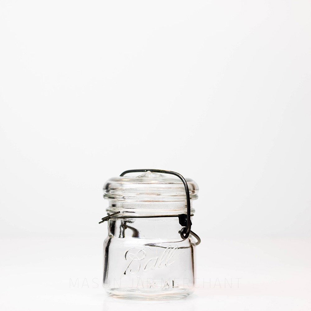 Vintage 1920s Ball wire bail half pint mason jar against a white background