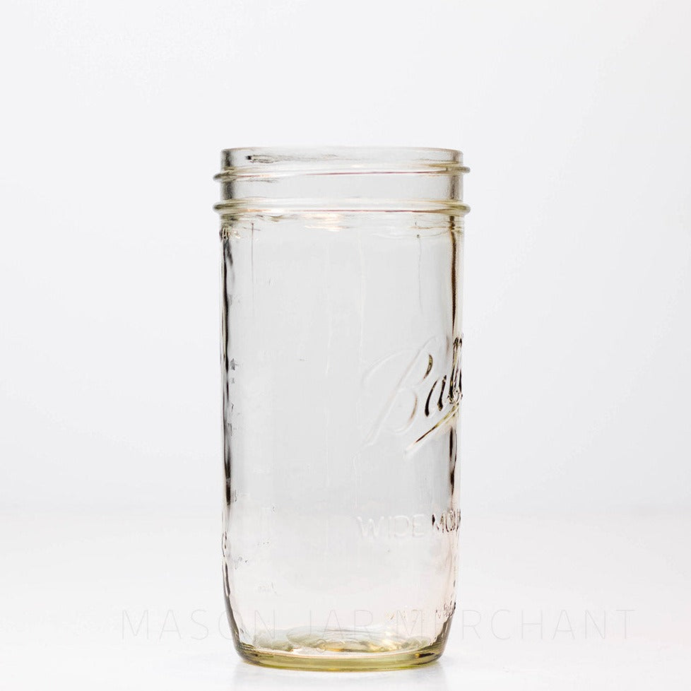 Side view of a 24 oz wide mouth Ball mason jar against a white background