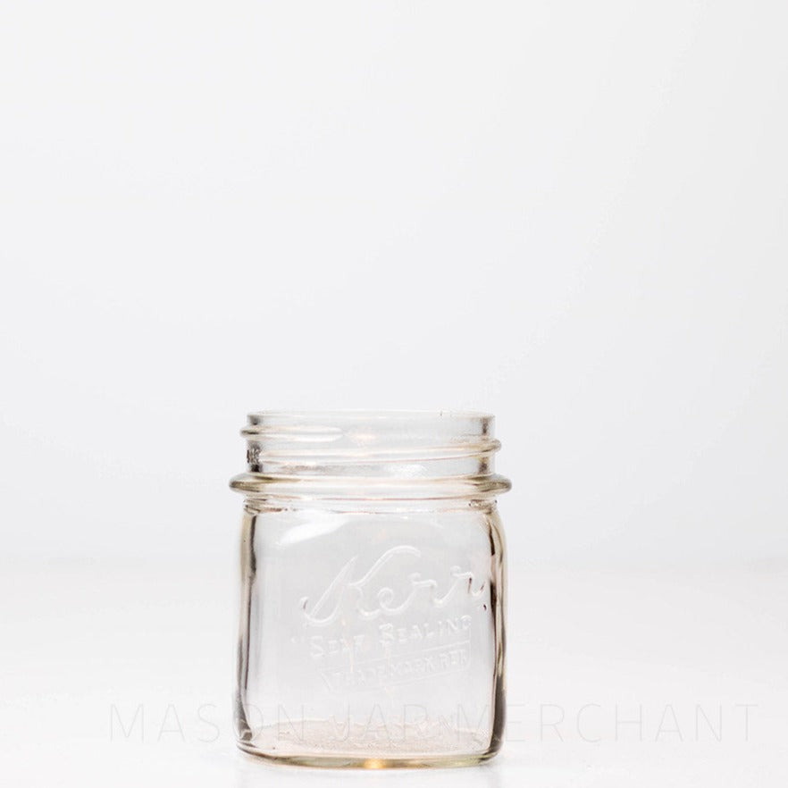 Regular mouth half-pint mason jar with Kerr self-sealing logo, against a white background