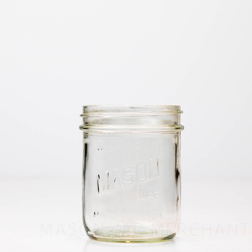 Mason brand wide mouth pint mason jar with logo showing, on a white background
