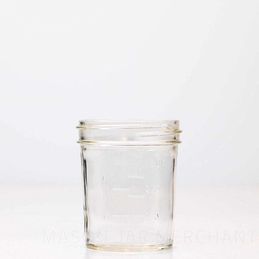 Regular mouth half pint mason jar with straight sides against a white background
