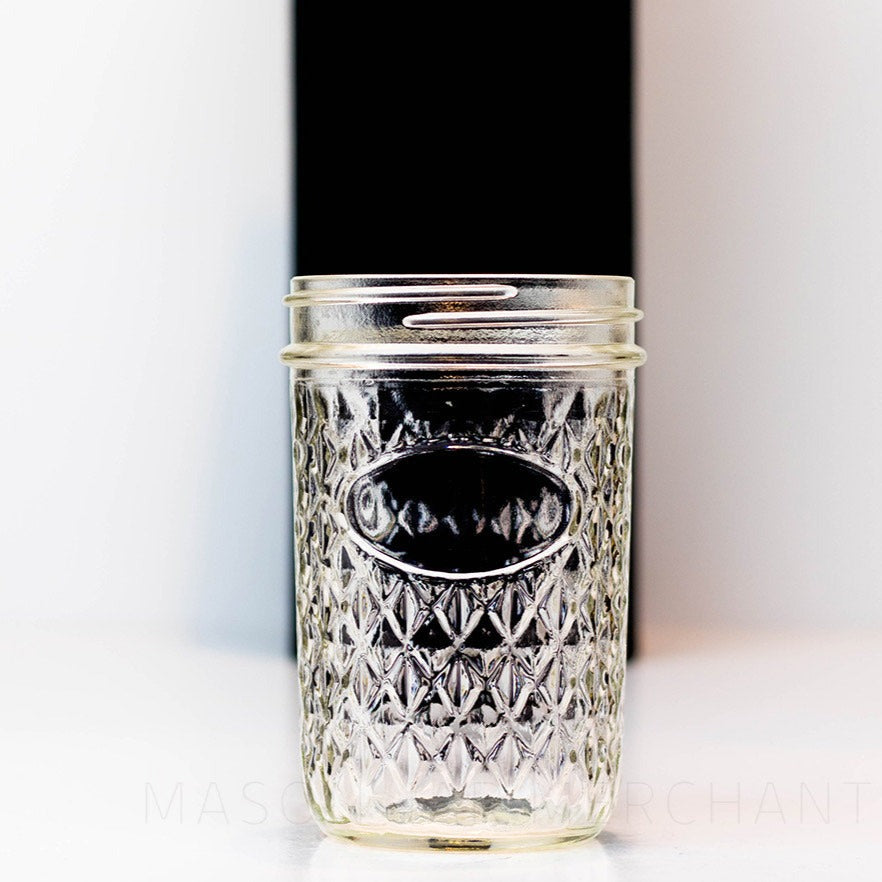 Close up details of a quilted wide mouth glass mason jar on a black and white background