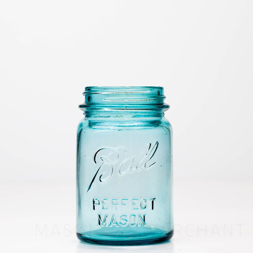 Vintage blue regular mouth Ball pint size mason jar against a white background