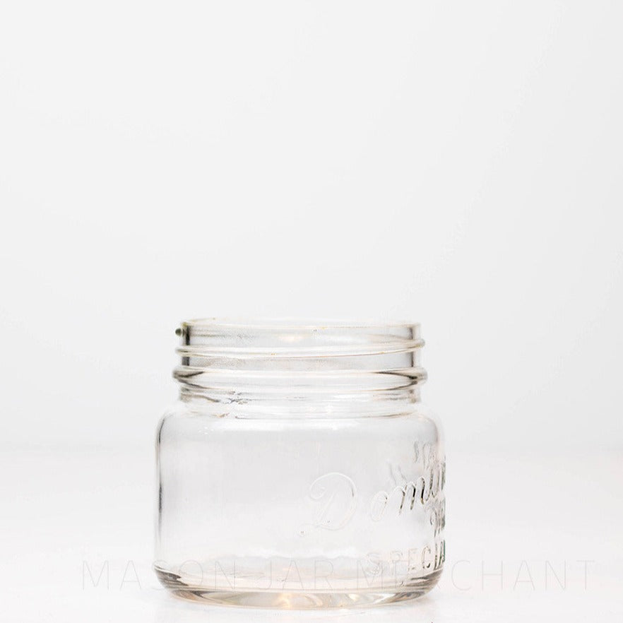 Vintage wide mouth pint mason jar with Dominion Special logo, against a white background