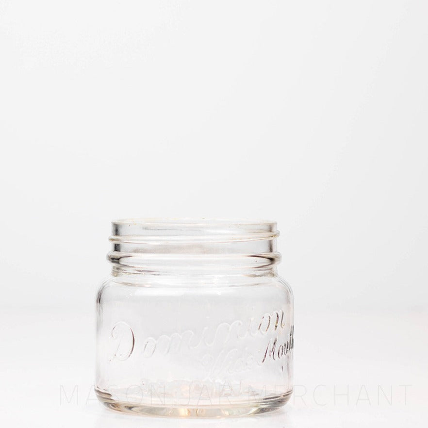 Vintage wide mouth pint mason jar with Dominion Special logo, against a white background