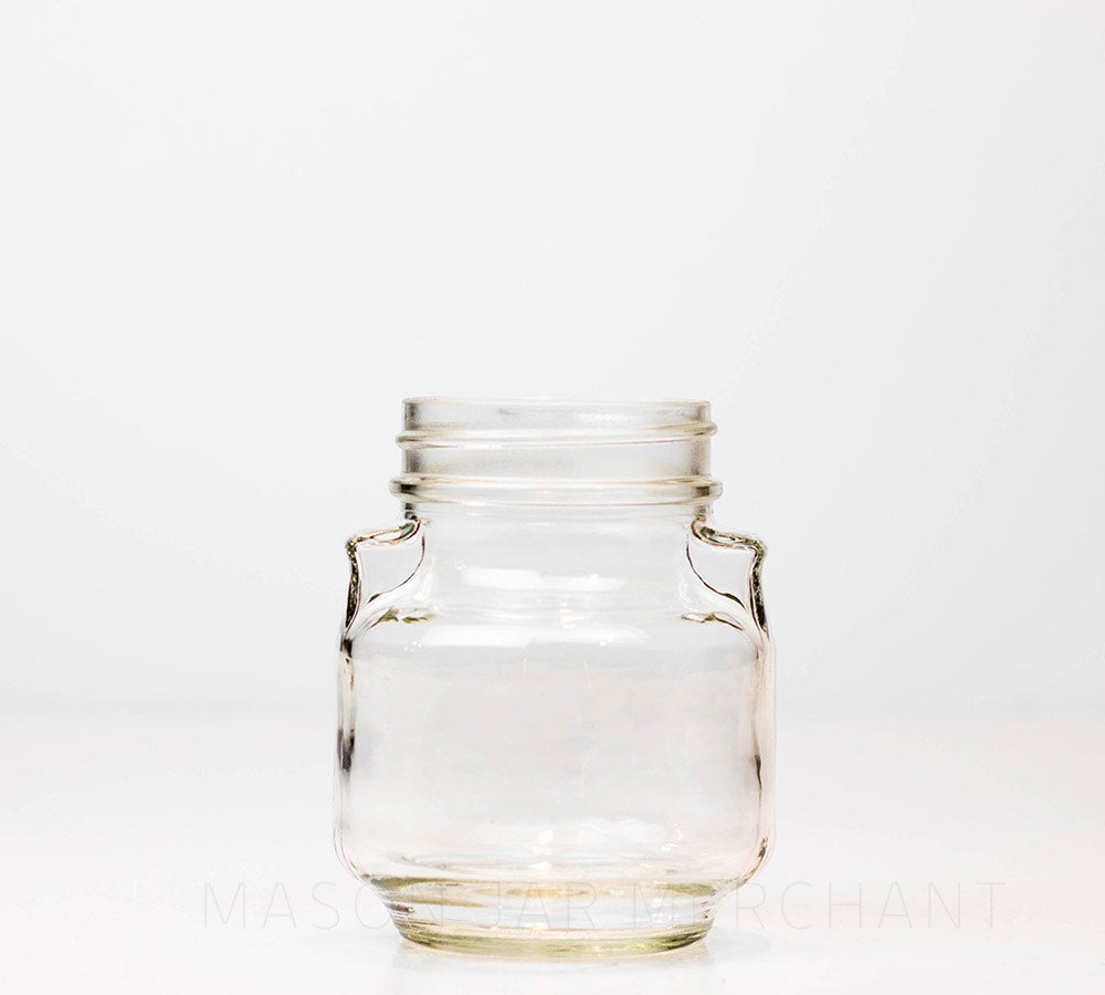 Regular mouth pint mason jar with unique pinched "shoulders" and no logo, against a white background