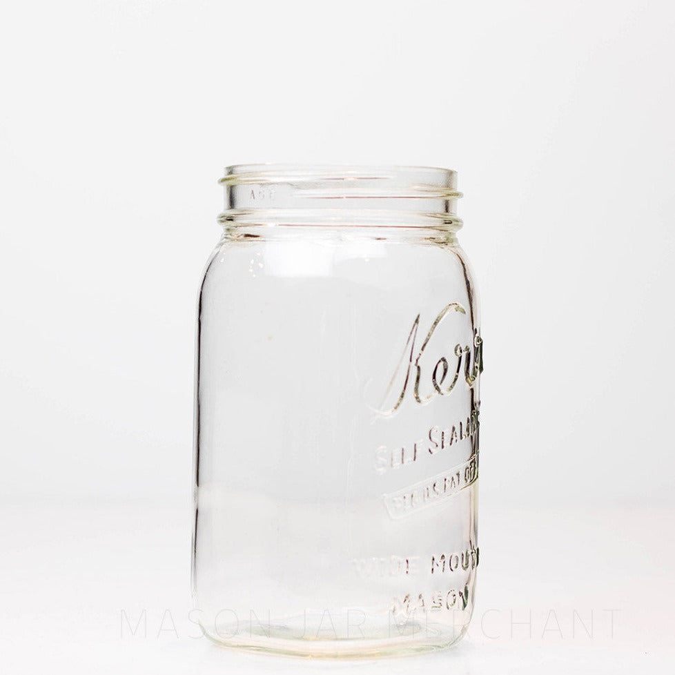 Side view of Wide mouth quart mason jar with Kerr self-sealing logo against a white background
