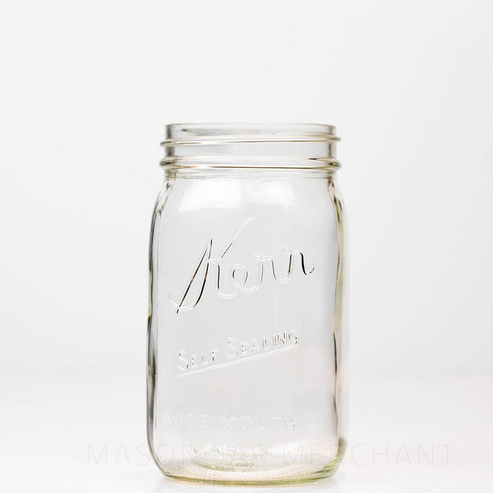 Kerr wide mouth quart mason jar with self-sealing logo, against a white background