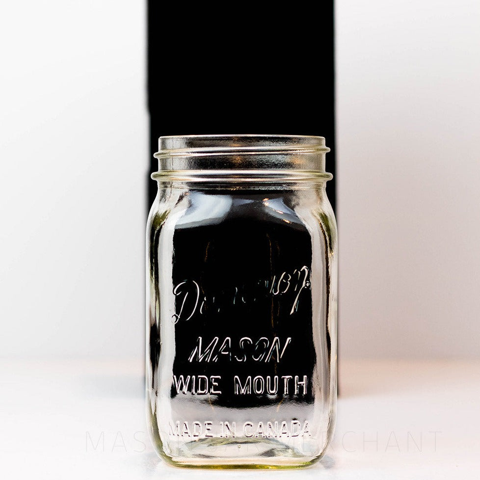 A close up of a Wide mouth quart mason jar with Dominion wide mouth Mason logo, against a white background
