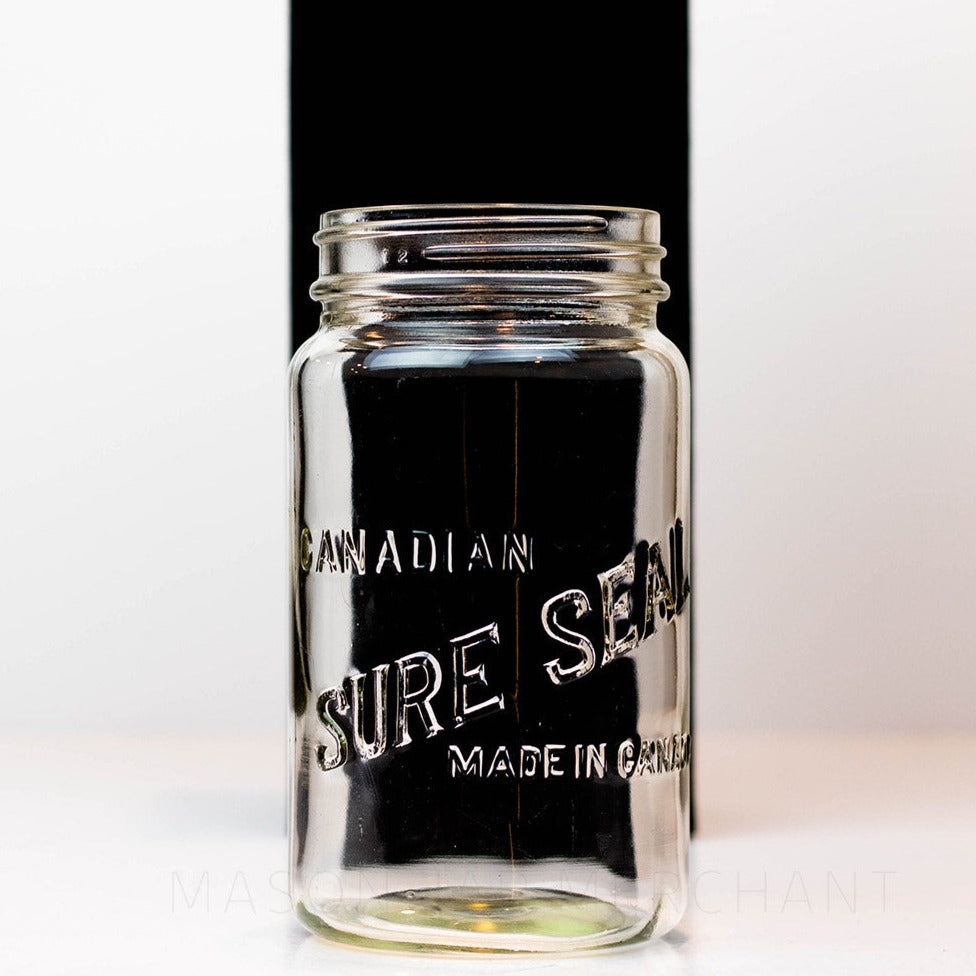 A close up of a Canadian Sure Seal wide mouth quart mason jar against a white background