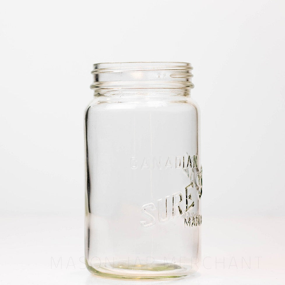 A side view of a Canadian Sure Seal wide mouth quart mason jar against a white background