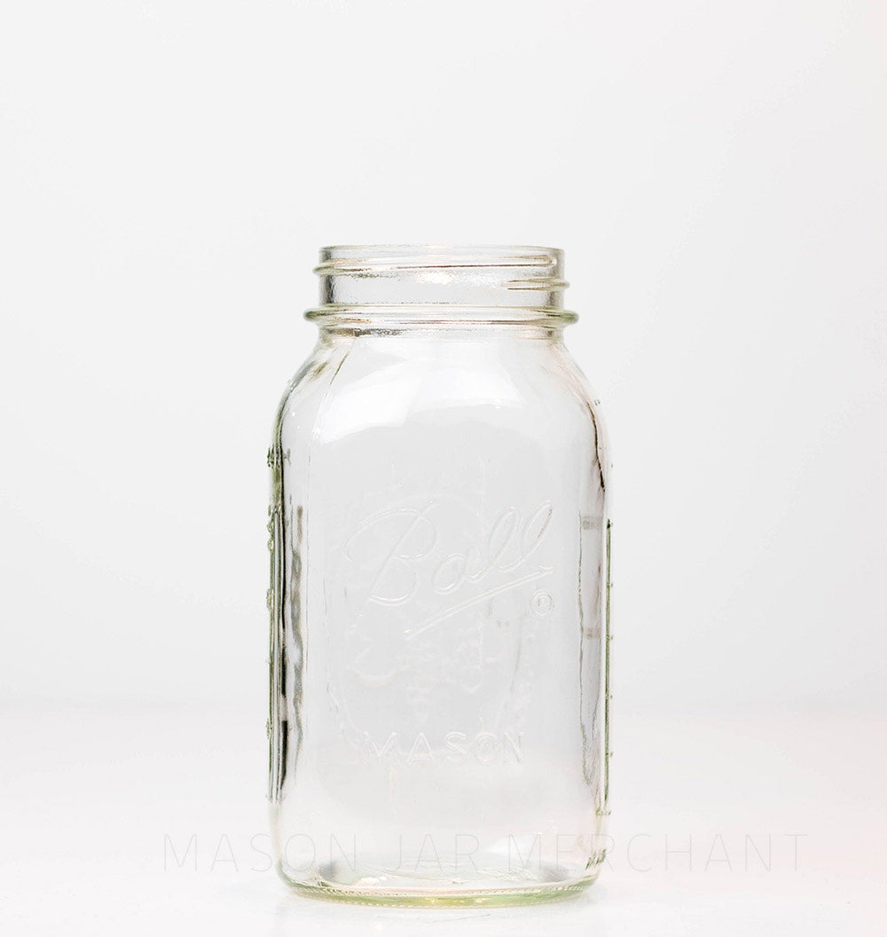 Ball wide mouth quart mason jar against a white background