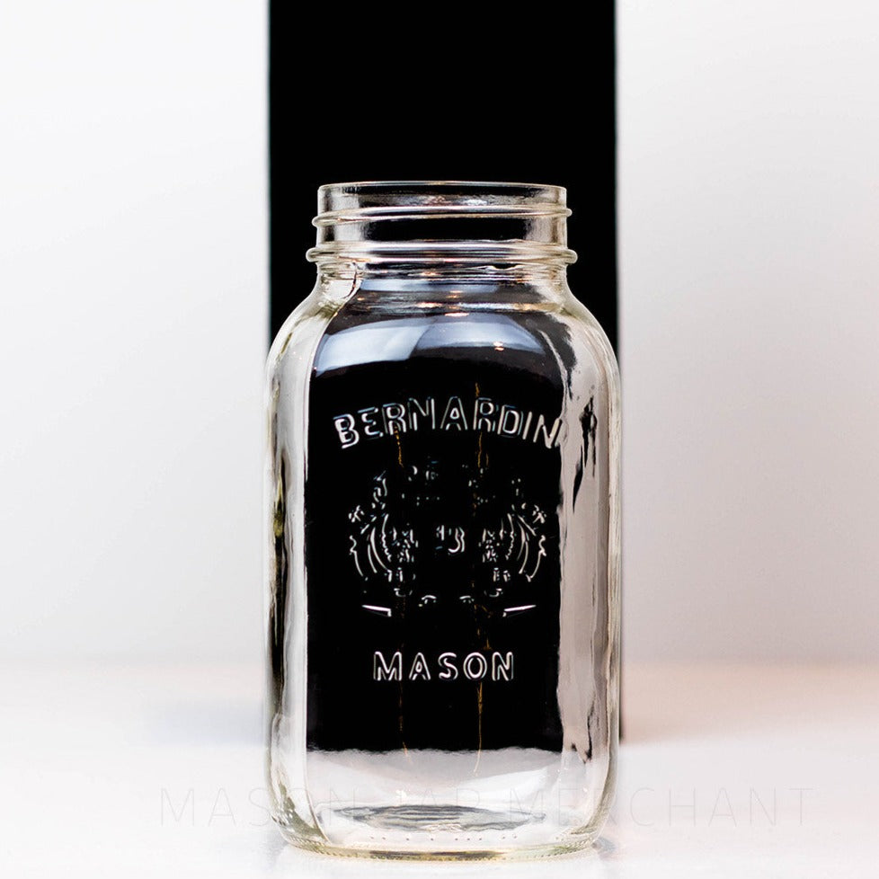 Close up of a Regular mouth quart mason jar with a Bernardin shield logo, against a white background