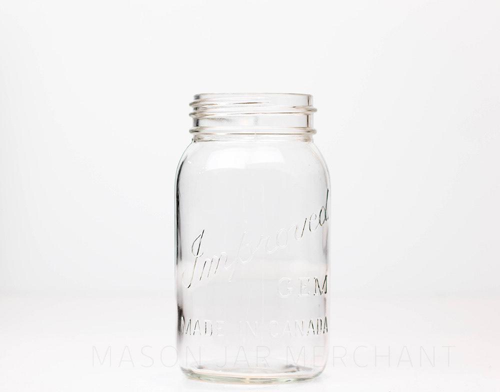 Vintage improved gem quart mason jar against a white background
