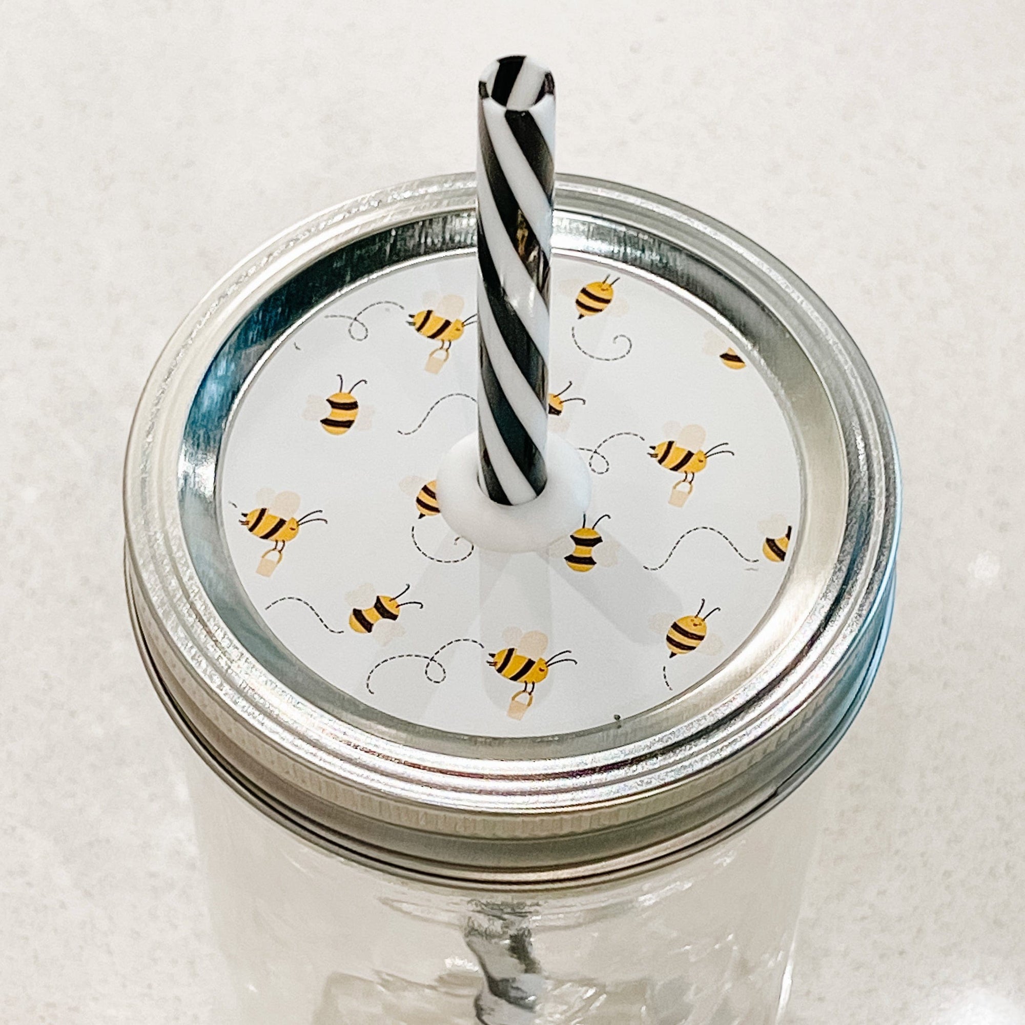 top photo of mason jar lid with bees flying around