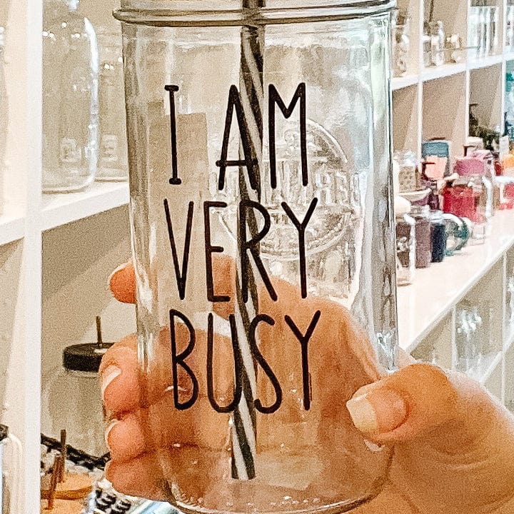 Photo of a mason jar tumblr with a 'I am very busy' sticker on it