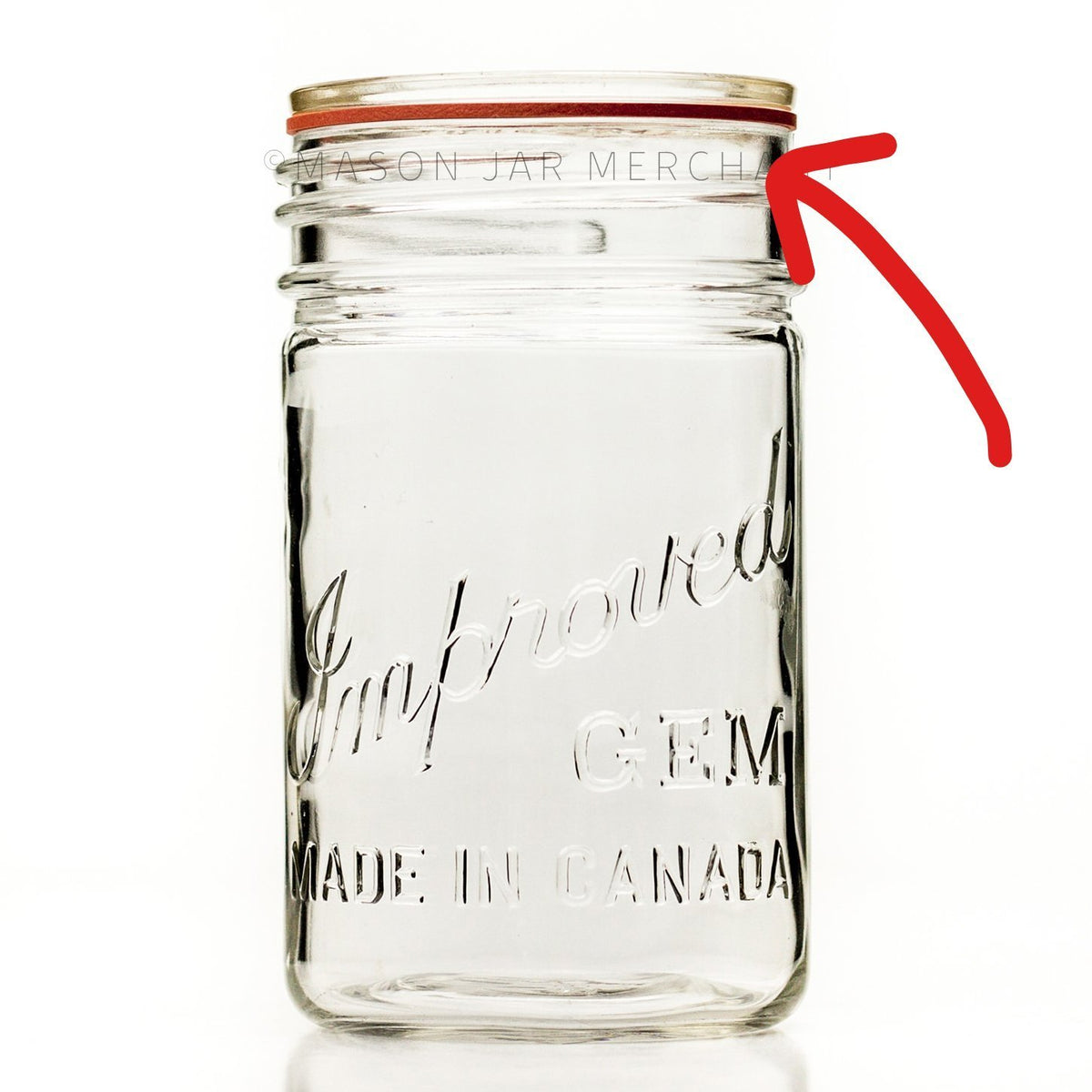 Improved GEM tall pint mason jar with red rubber seal and glass flat lid on a white background