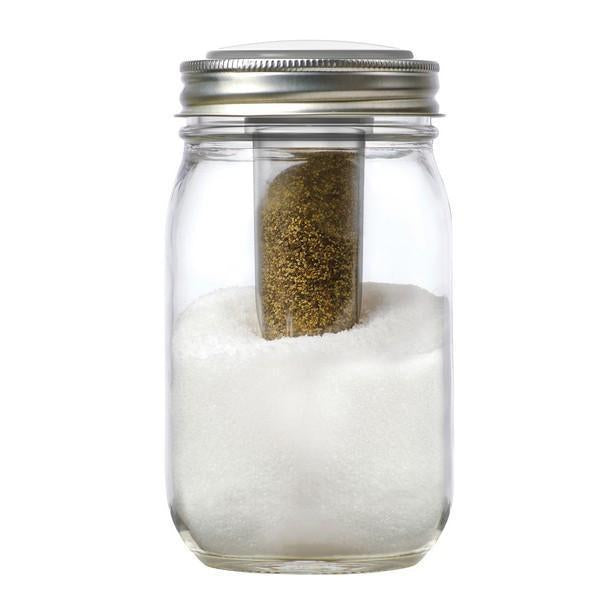 Jarware salt and pepper shaker mason jar lid attachment shown with salt and pepper in a pint size mason jar on a white background.