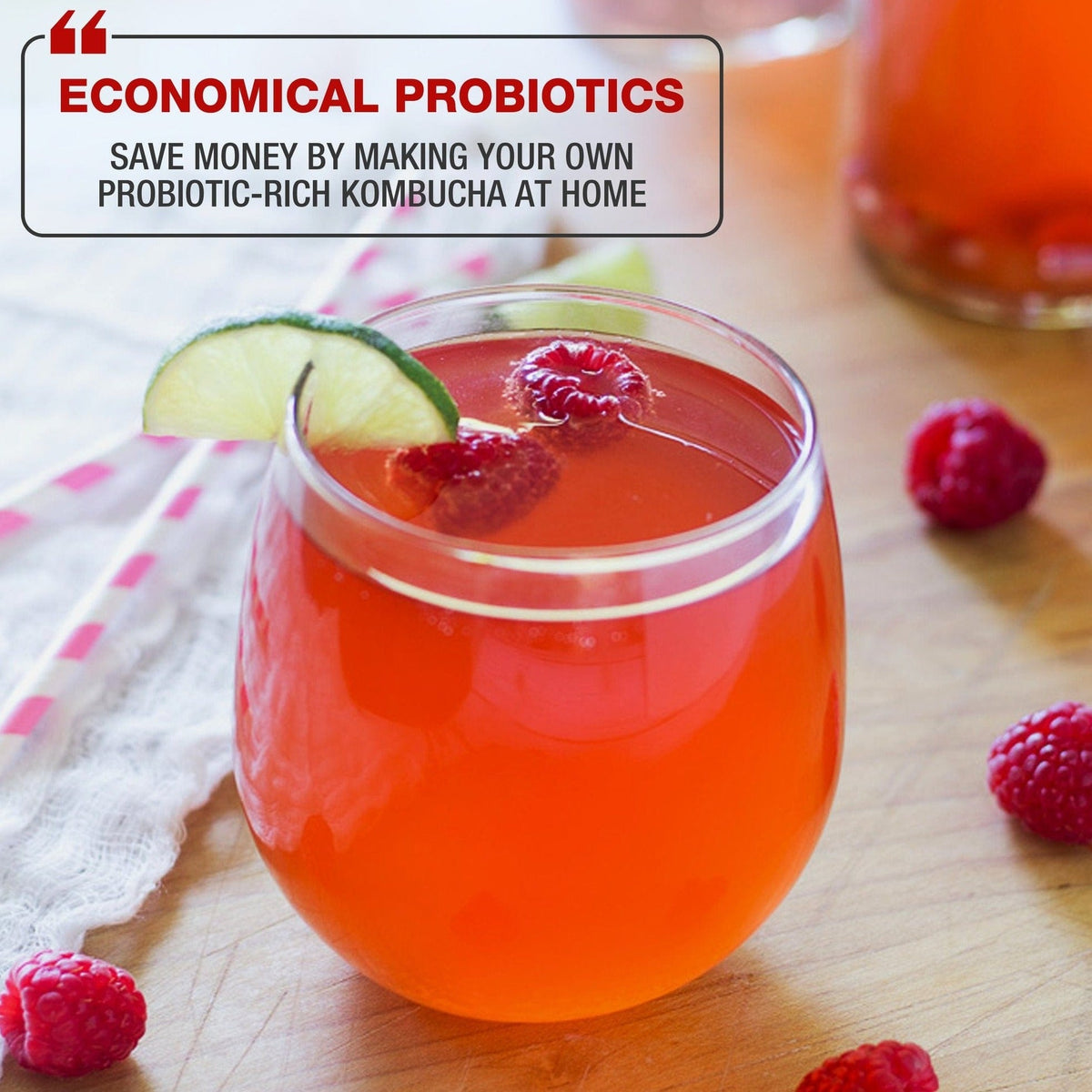 A photo of a glass with raspberry, lime, and probiotic-rich kombucha in a table